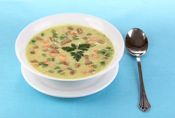 Tasty soup on blue tablecloth isolated on white