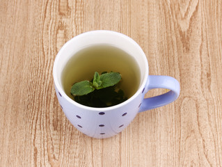 Mint tea with mint leaf on wooden background