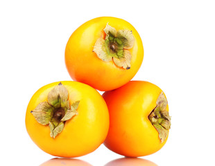 Three appetizing persimmons isolated on white