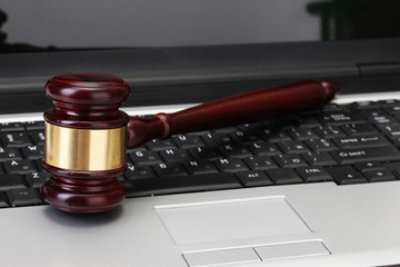 wooden gavel on laptop computer close up