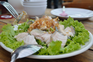 Poached fish with garlic sauce
