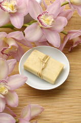 bowl of natural Soap and pink orchids