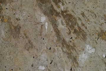 textured concrete wall with remnants of paper.