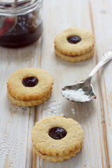 Cookies with berries jam and powdered sugar