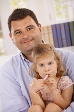Portrait of father and little daughter smiling