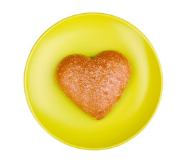 Heart-shaped cookie on saucer isolated on white