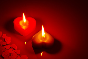 Two burning heart shaped candle