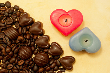 Two heart shaped candles and candies