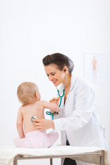 Pediatrician doctor examine kid using stethoscope