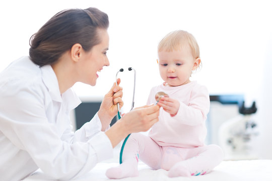 Pediatrician doctor showing baby stethoscope