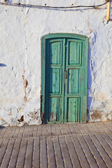 old chalked house wall with window and door