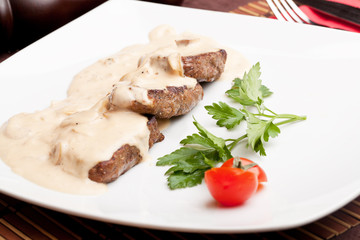 Roasted meat under white sauce