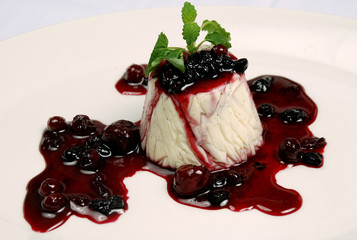Milk dessert with cherry jam.