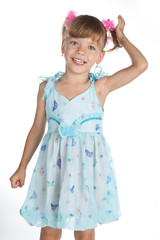 Portrait of a cute little girl in blue dress