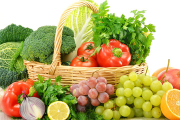 Composition with vegetables and fruits in wicker basket isolated
