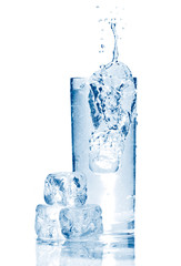 Water splash in glasse with ice isolated on white