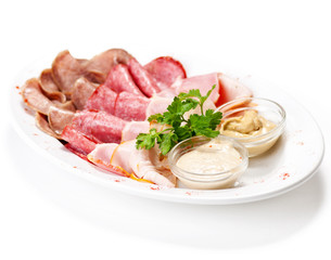 Meat delicatessen plate with souce
