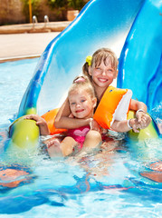 Children on water slide at aquapark.