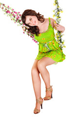 Girl swinging on flower swing.