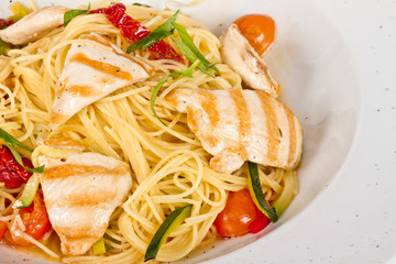 close-up of plate of pasta and chicken