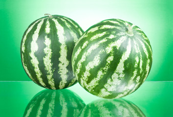Two Watermelons isolated on a green background