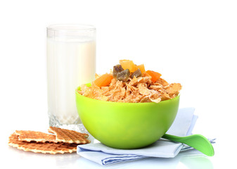 tasty cornflakes in green bowl and glass of milk isolated