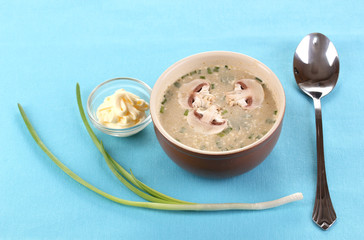 Tasty soup on blue tablecloth