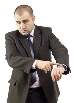 Serious adult businessman pointing to his watch