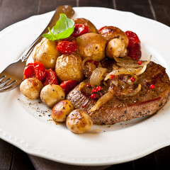 Rustic meat dish with oven baked vegetables and mushrooms