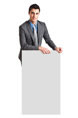 Handsome businessman showing a blank board