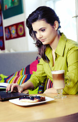 Beautiful young college student on a cafe.