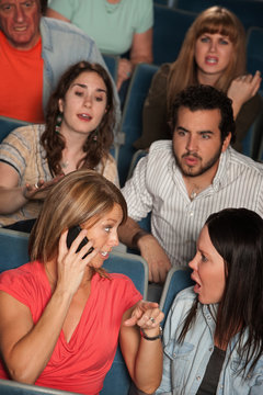 Women On Phone in Theater