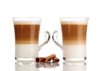 Fragrant сoffee latte in glass cups and cinnamon isolated