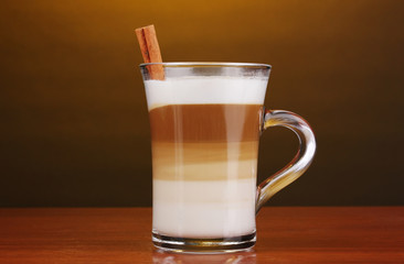Fragrant сappuccino latte in glass cup and cinnamon