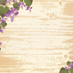 wooden background with violet flowers