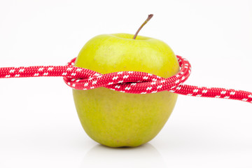 green apple with red rope