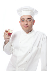 Cook eating red apple
