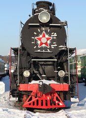 locomotive at a train station in winter,  front view