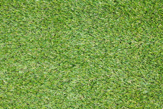 Background texture with fake grass in a public children playgrou