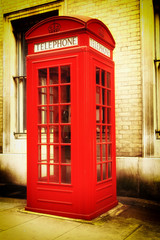 Retro image of a typical red London phone booth