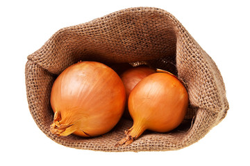 Open jute sack with ripe onions over white background.