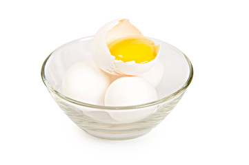 three eggs in glass vase on white