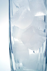 glass goblet with ice on blue background