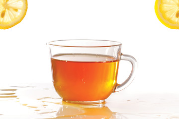 Cup of ice tea and lemon on a white background