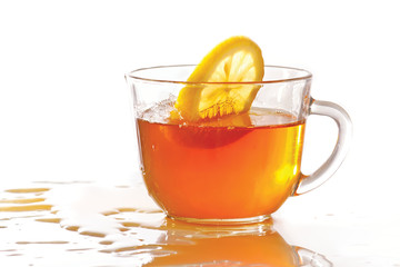 Cup of ice tea and lemon with splash on a white background