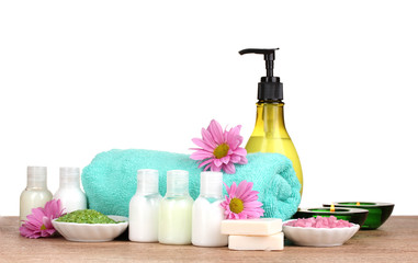 Hotel amenities kit on wooden table on white background