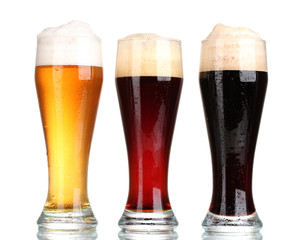 three glasses with different beers isolated on white