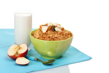 tasty cornflakes in bowl with dried fruits, glass of milk and
