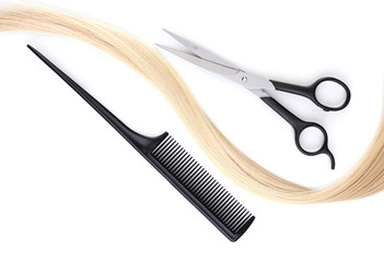 Shiny blond hair with hair cutting shears and comb isolated