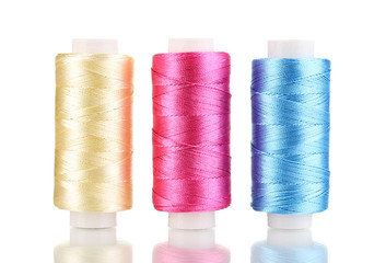 Three bobbin thread isolated on white